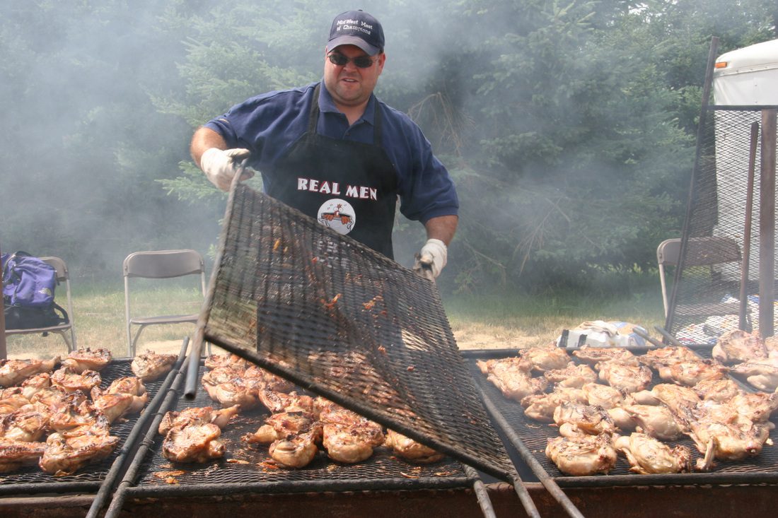 Man lifting up grilling grate