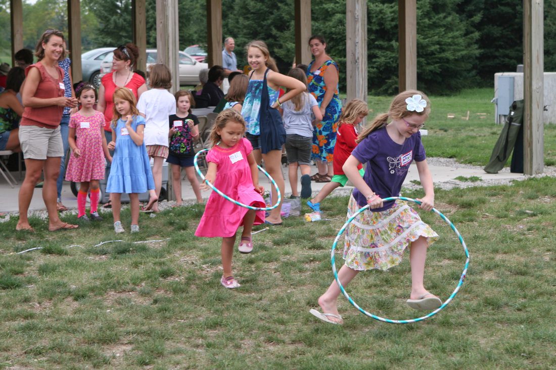 Girls running with hula hoops